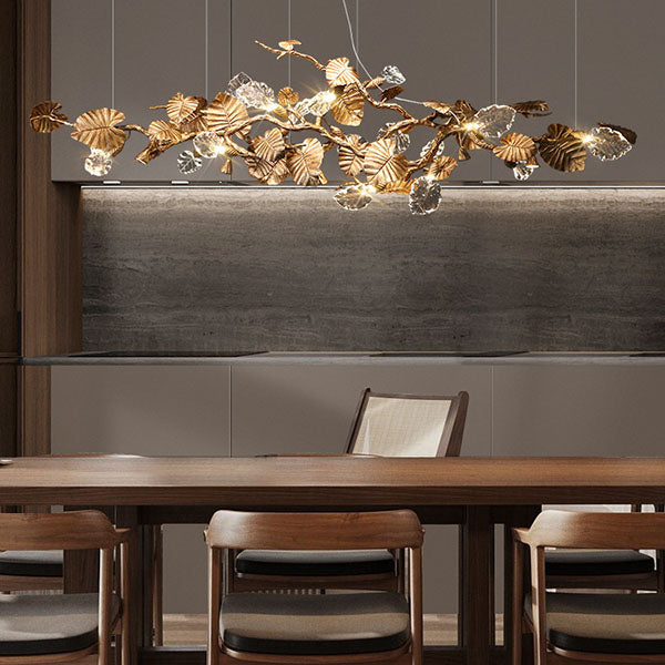 Elegant Lotus chandelier featuring delicate lotus leaf pendants made of transparent material, capturing light with a crystalline shimmer. The slender, organic brass copper branch adds warmth, while the LED lights provide a cool glow. Ideal centerpiece for a sophisticated dining area or tranquil bedroom retreat.